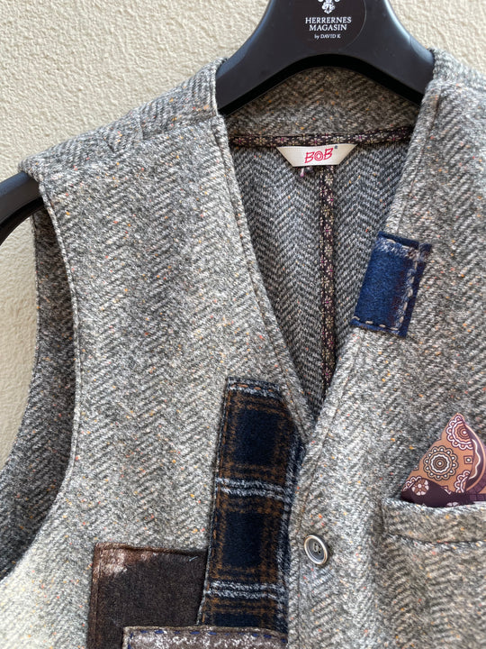 Grøn vest med sildeben og patchwork